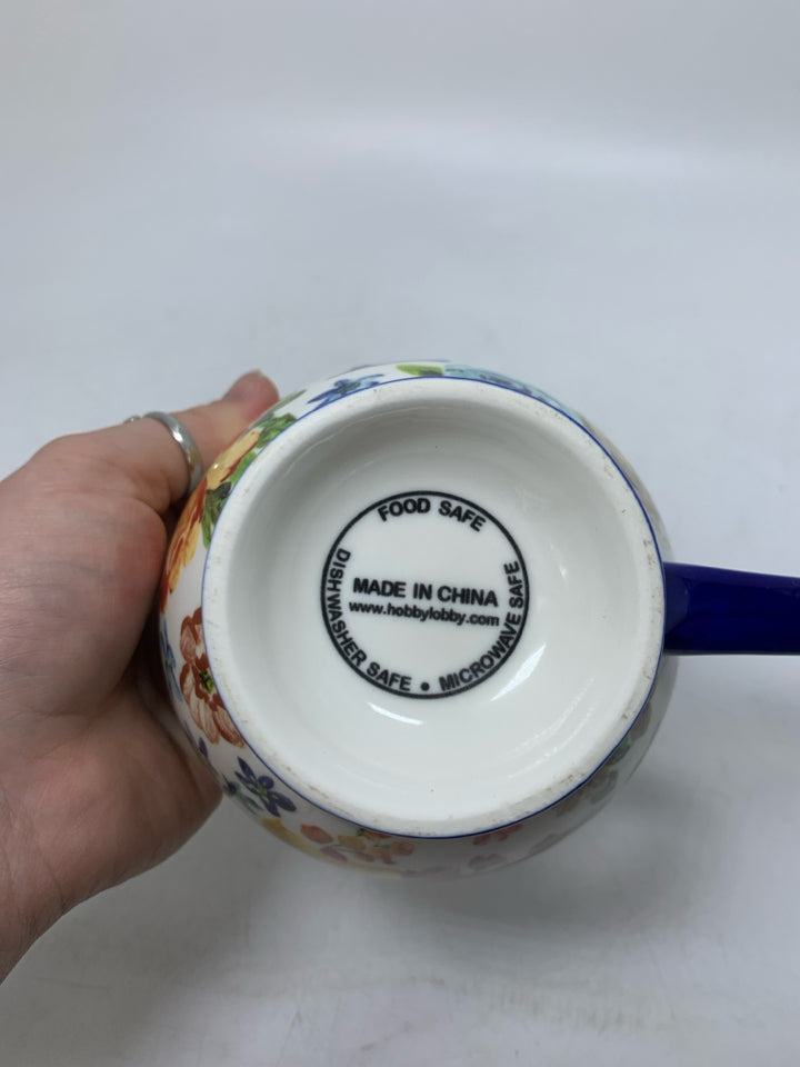 FOOTED FLORAL MONOGRAM E MUG.