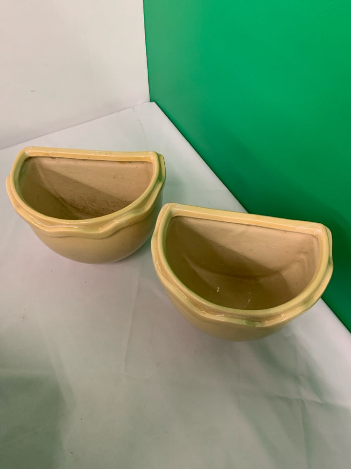 2 TAN CERAMIC WALL HANGING PLANTERS.