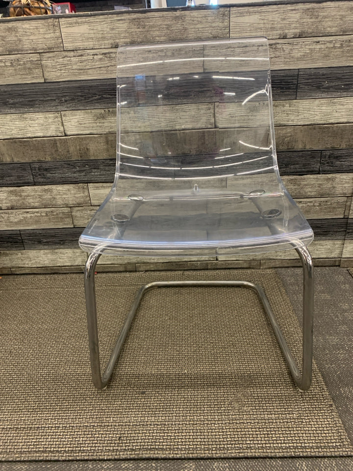 CLEAR IKEA CHAIR W/ METAL BOTTOM.