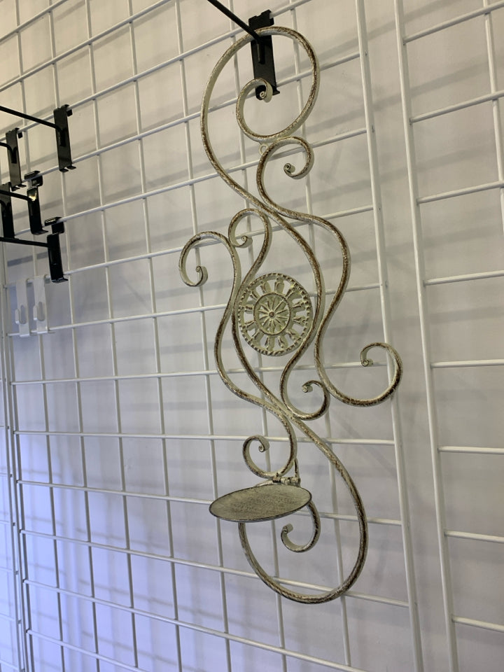 METAL CREAM AND GOLD SCROLL CANDLE HOLDER WALL HANGING.
