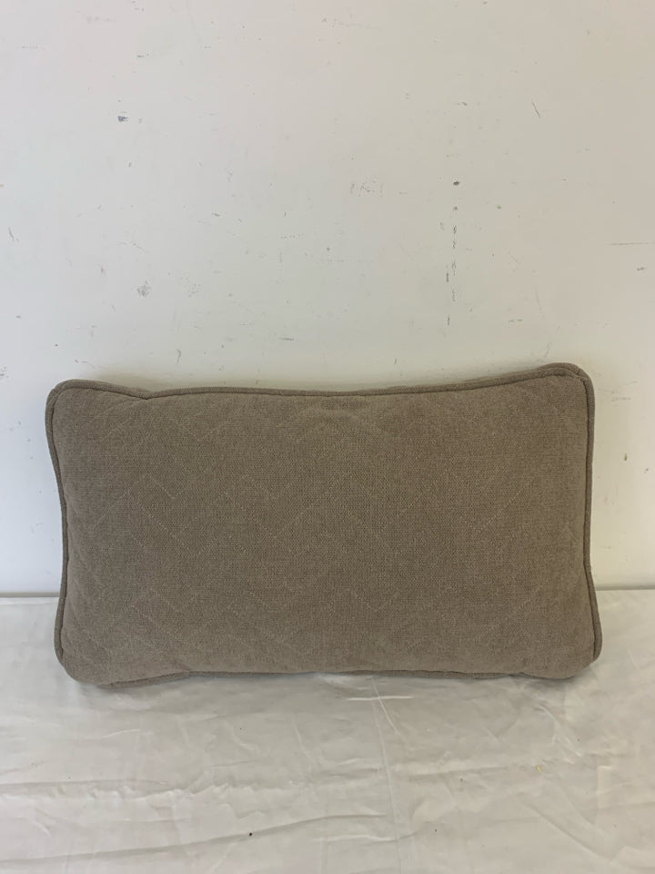 RECTANGLE DARK TAN PILLOW W/ ZIG ZAG STITCHING.