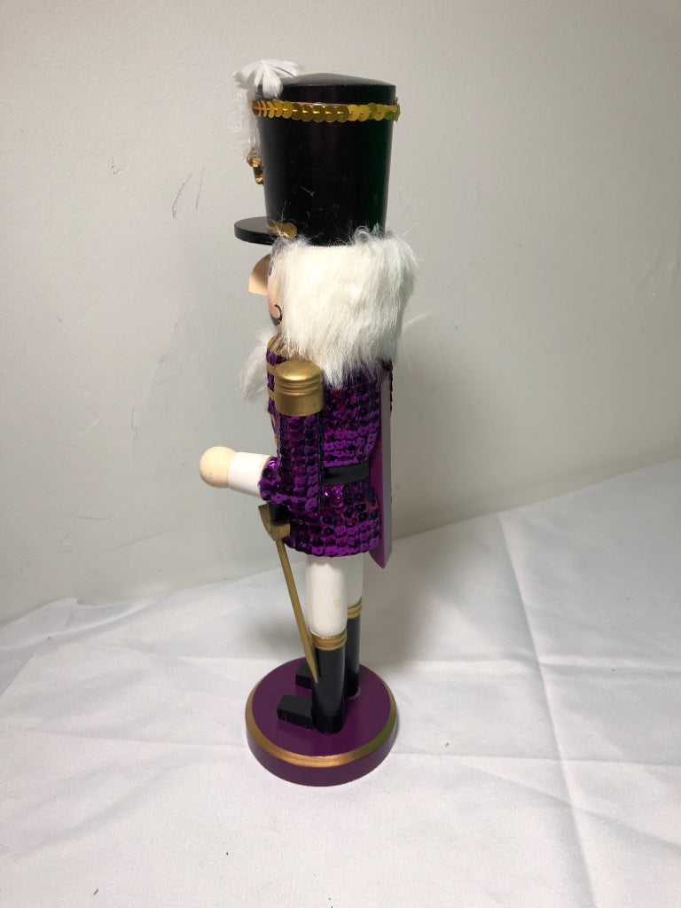 PURPLE SEQUIN NUT CRACKER.