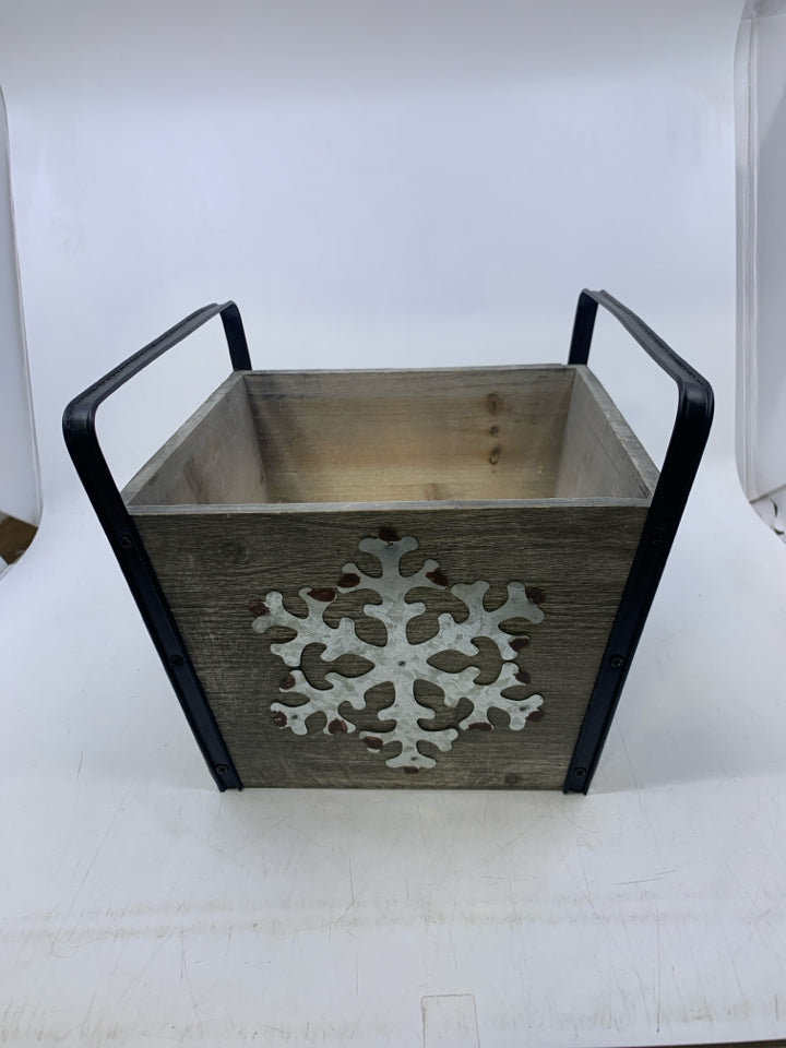 GREY PLANTER W/ GALVANIZED METAL SNOWFLAKE BLACK HANDLES.