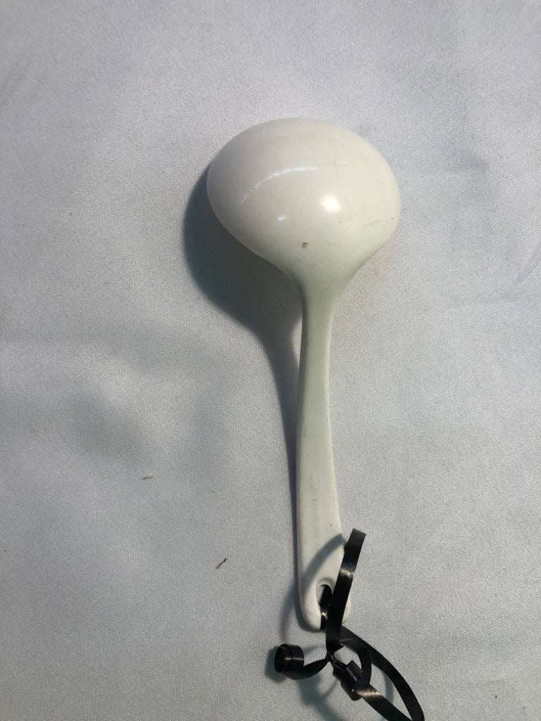 WHITE SERVING SPOON W/ ORANGE FLOWER ON HANDLE.