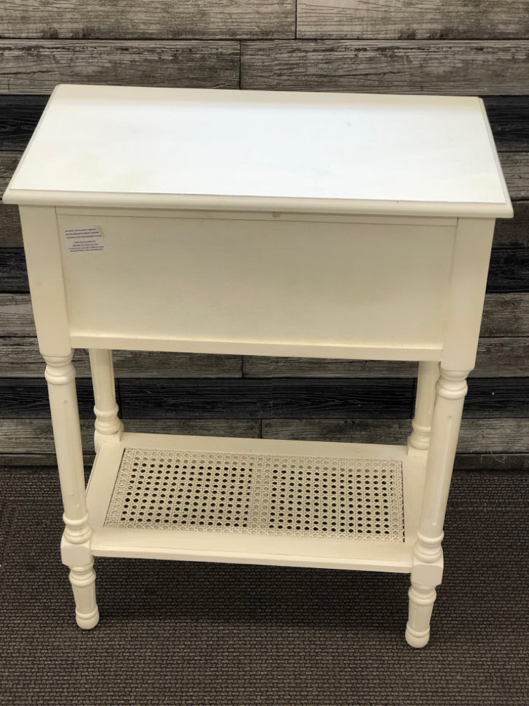 WHITE WOOD SIDE TABLE W/3 DRAWERS AND CANE BOTTOM SHELF.
