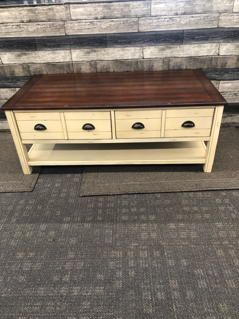 CREAM AND DARK WOOD TOP DISTRESSED COFFEE TABLE.