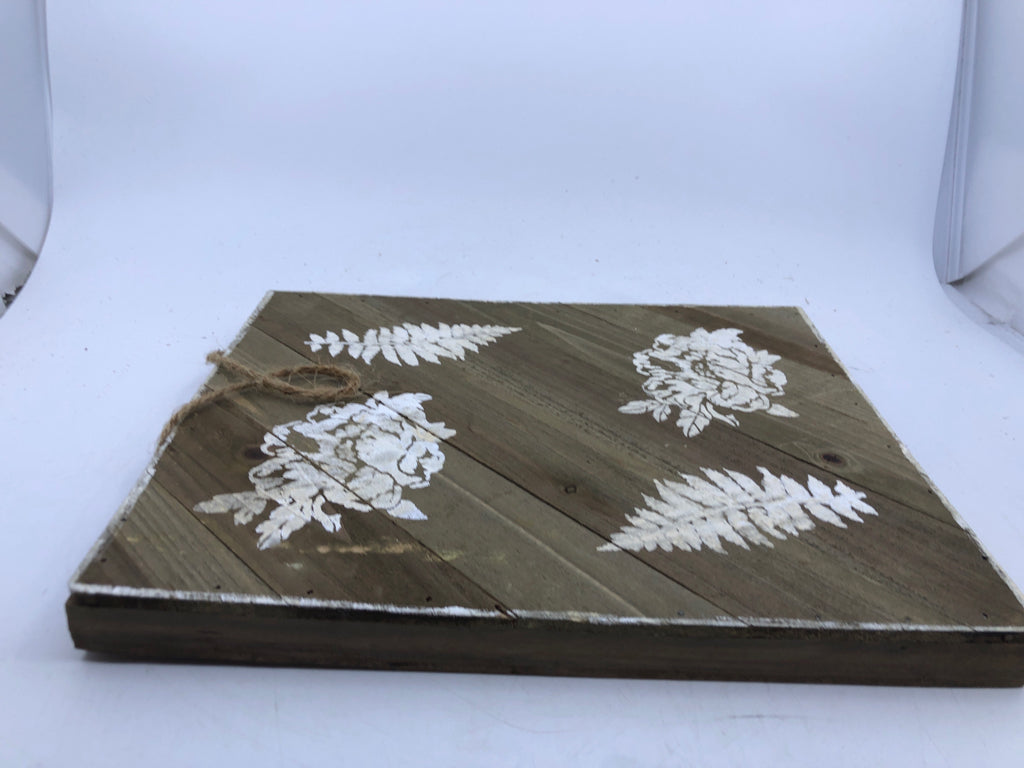 WOOD SIGN WITH WHITE PAINTED LEAVES/FLOWERS.