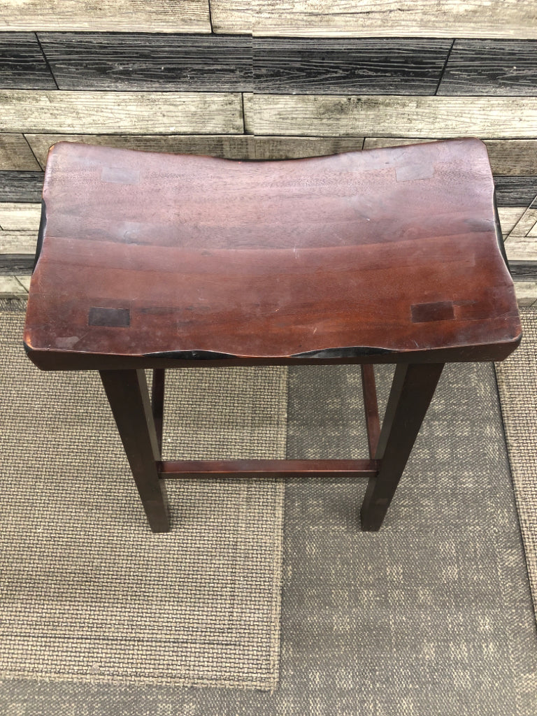 DARK WOOD TALL SADDLE STOOL.