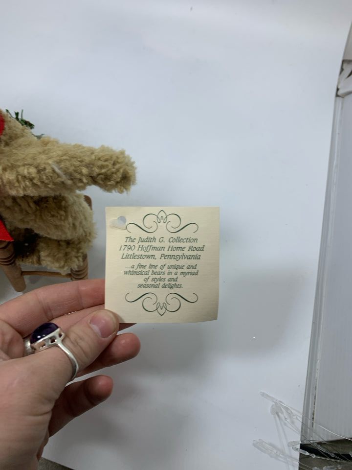BOYDS BEAR SMALL BEAR PUTTING LIGHT ON TREE STANDING ON CHAIR.