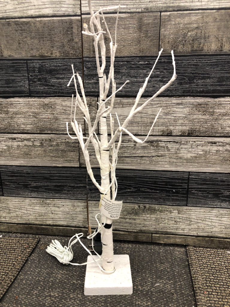 WHITE & BLACK DISTRESS LIGHT UP TREE ON WHITE BASE.