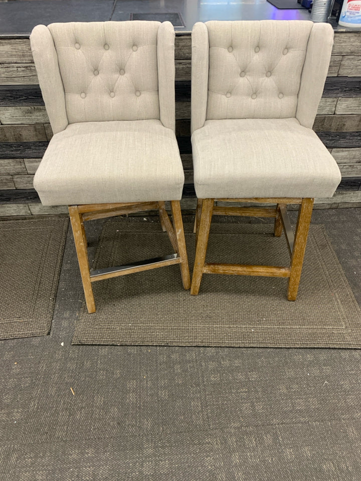 2 GRAY UPHOLSTERED SWIVEL CHAIRS.