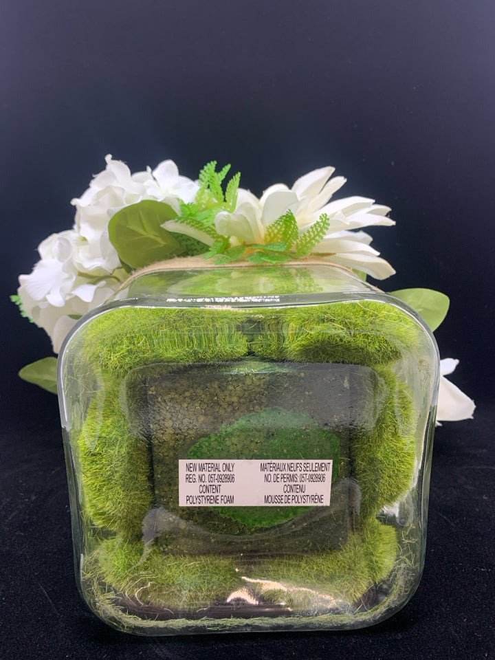 WHITE FLOWERS IN SQUARE GLASS VASE.