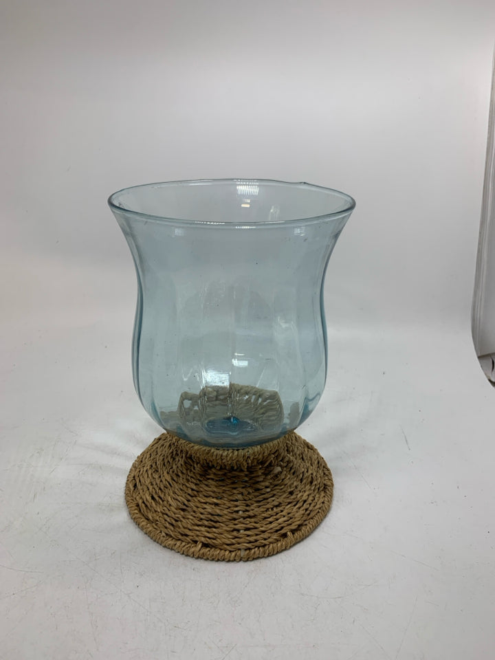 BLUE TINTED GLASS W/ WOVEN BASE CANDLE HOLDER.