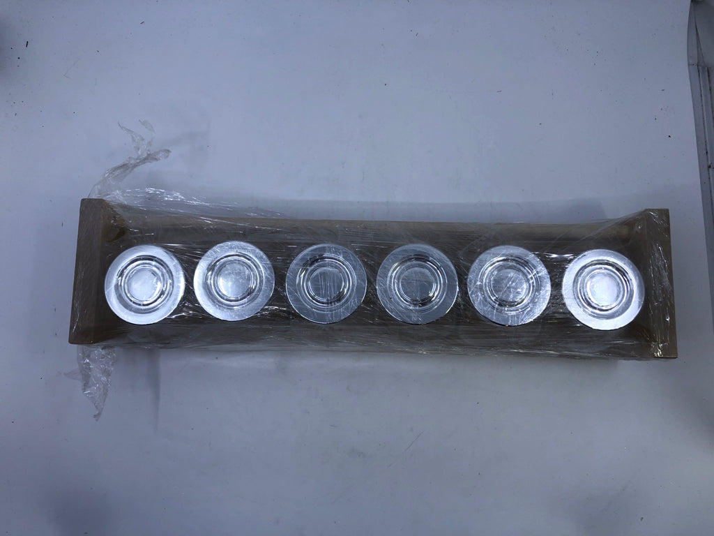 GLASS JARS IN WHITE SHELF.