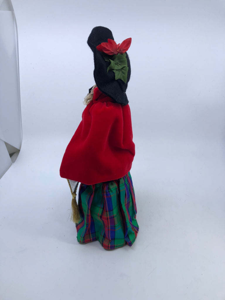 BYERS' CHOICE WOMAN IN RED COAT AND PLAID DRESS.