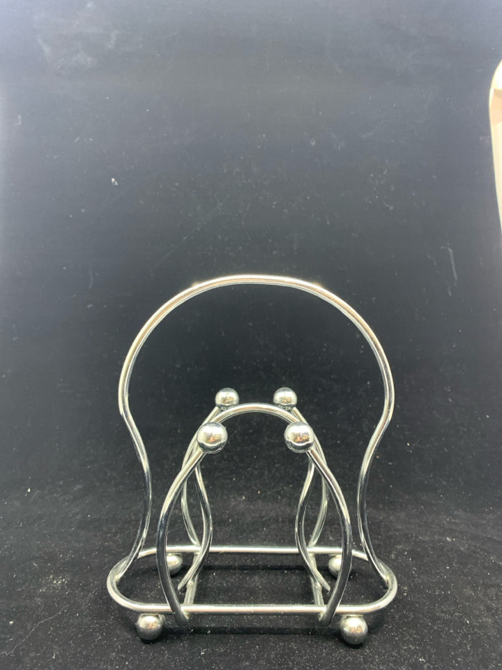 SILVER METAL NAPKIN HOLDER.