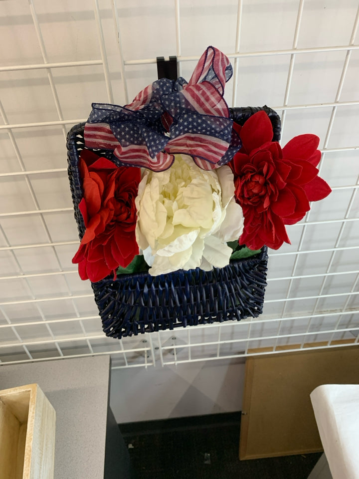 RED WHITE AND BLUE BOUQUET IN BLUE BASKET.
