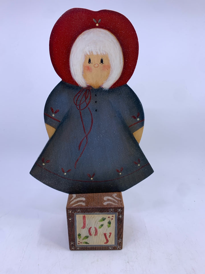 WOOD GIRL IN BLUE DRESS ON "JOY" BLOCK.