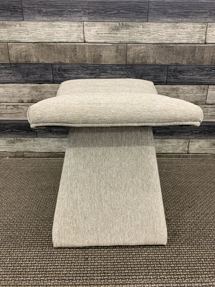 GREY TUFTED CURVED FOOTSTOOL.