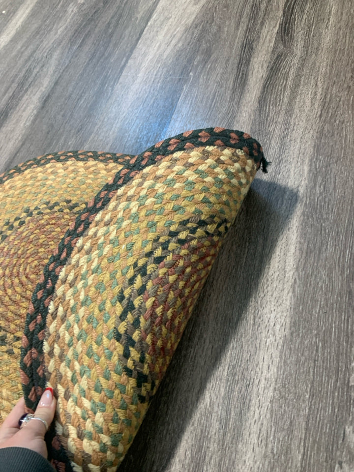 OVAL BRAIDED RUG.