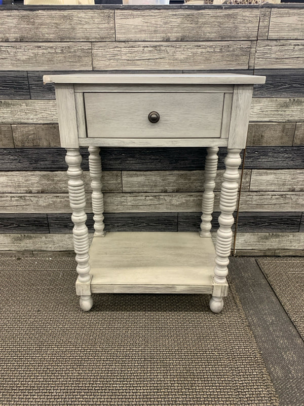 GRAY SIDE TABLE W/ DRAWER DETAILED LEGS.