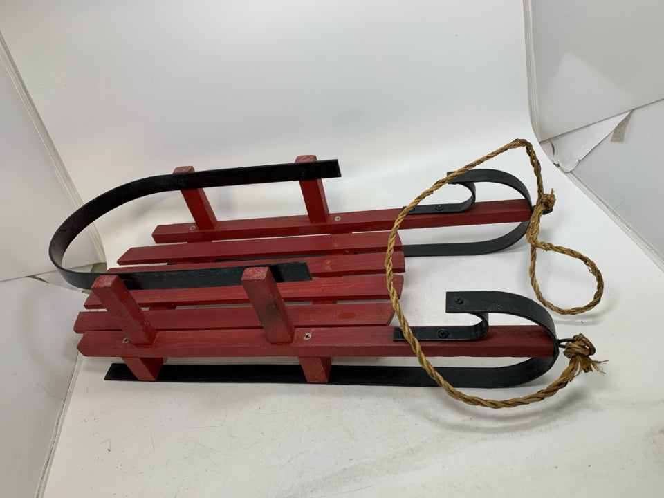 HEAVY WOOD RED SLED W/ METAL FEET.