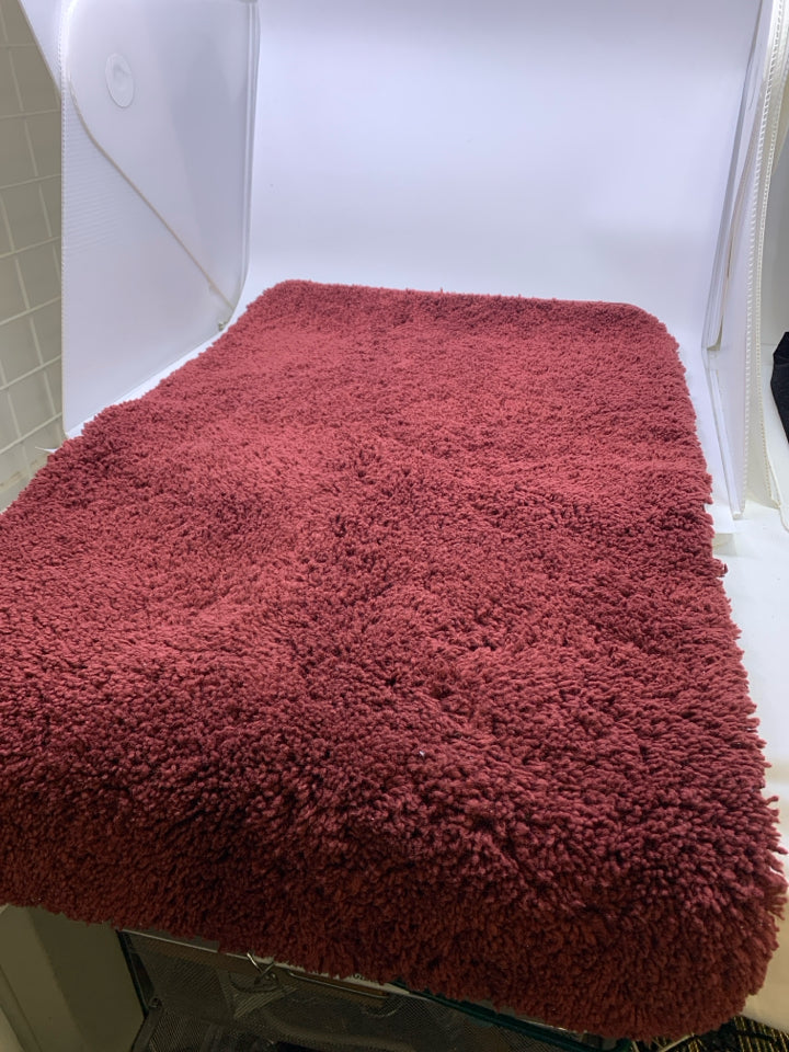 RED BATH MAT.