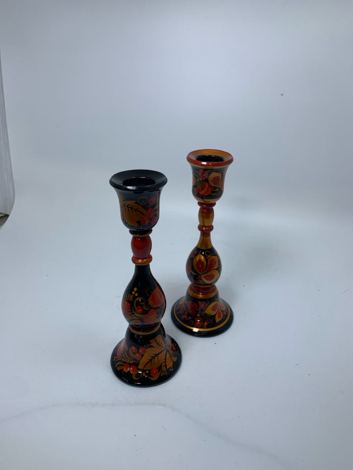 2 PAINTED RUSSIAN RED/BLACK FLORAL WOODEN TAPERED CANDLE HOLDERS.