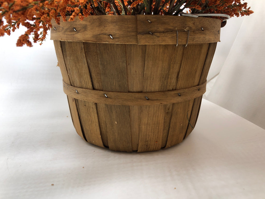 ORANGE PIP IN BUSHEL BASKET.