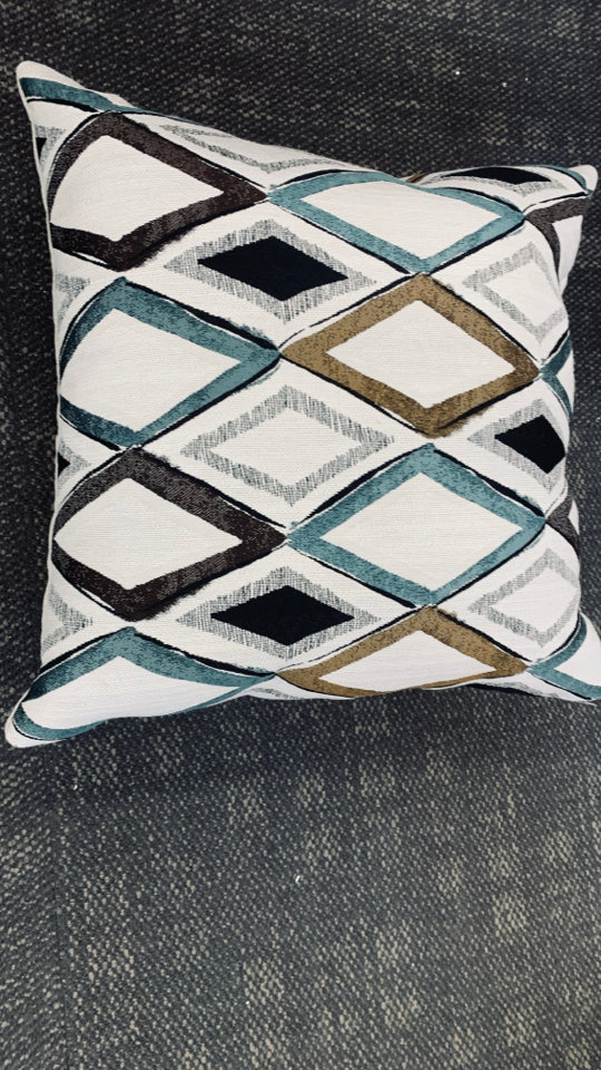 WHITE ACCENT PILLOW TEAL/BROWN/BLACK TRIANGLE DESIGN.