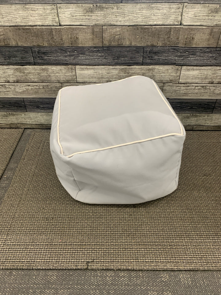 GREY CUBE OTTOMAN W WHITE ACCENT.