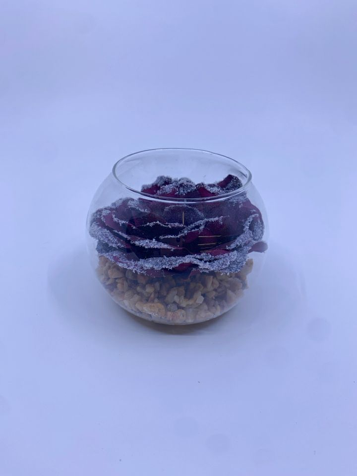 PURPLE FLORAL AND STONES IN GLASS JAR.