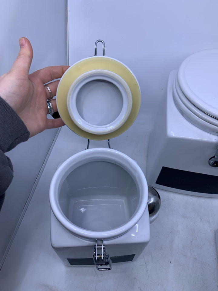 3 PC WHITE CANISTER SET W/ CHALK BOARD LABEL AND METAL SPOONS.