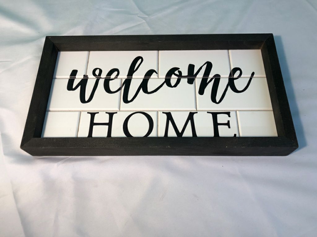 WELCOME HOME FAUX WHITE BRICK WALL ART W/ BLACK WOOD FRAME.
