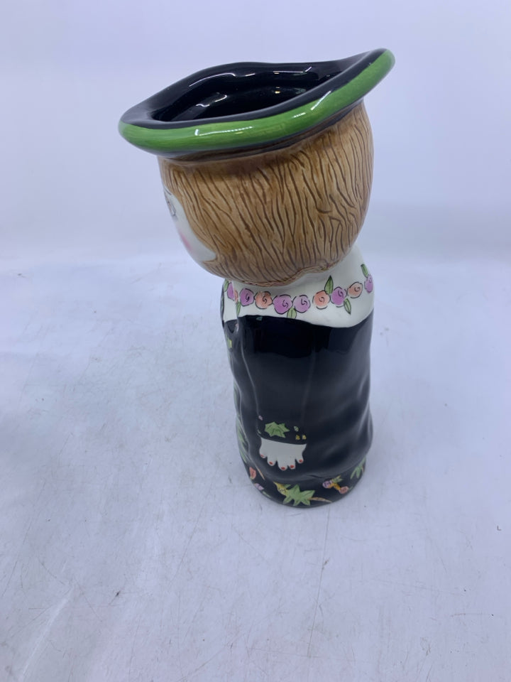 WOMAN SHAPED VASE W/ BLACK DRESS FLOWER NECKLACE.