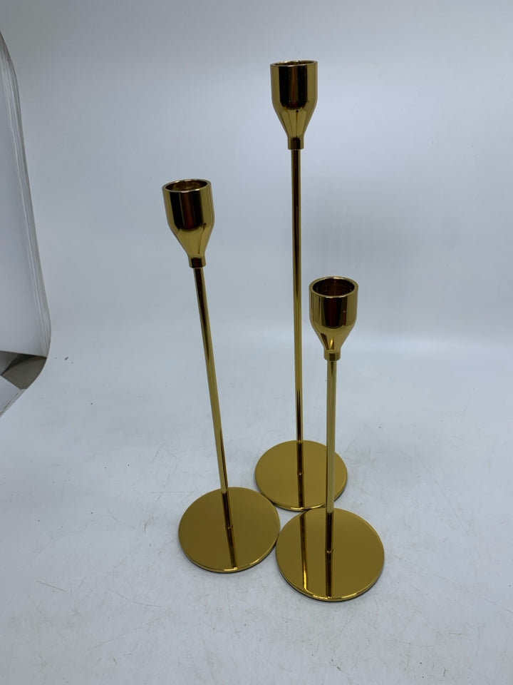 3 GOLD SKINNY TAPERED CANDLE HOLDERS DIFFERENT SIZES.