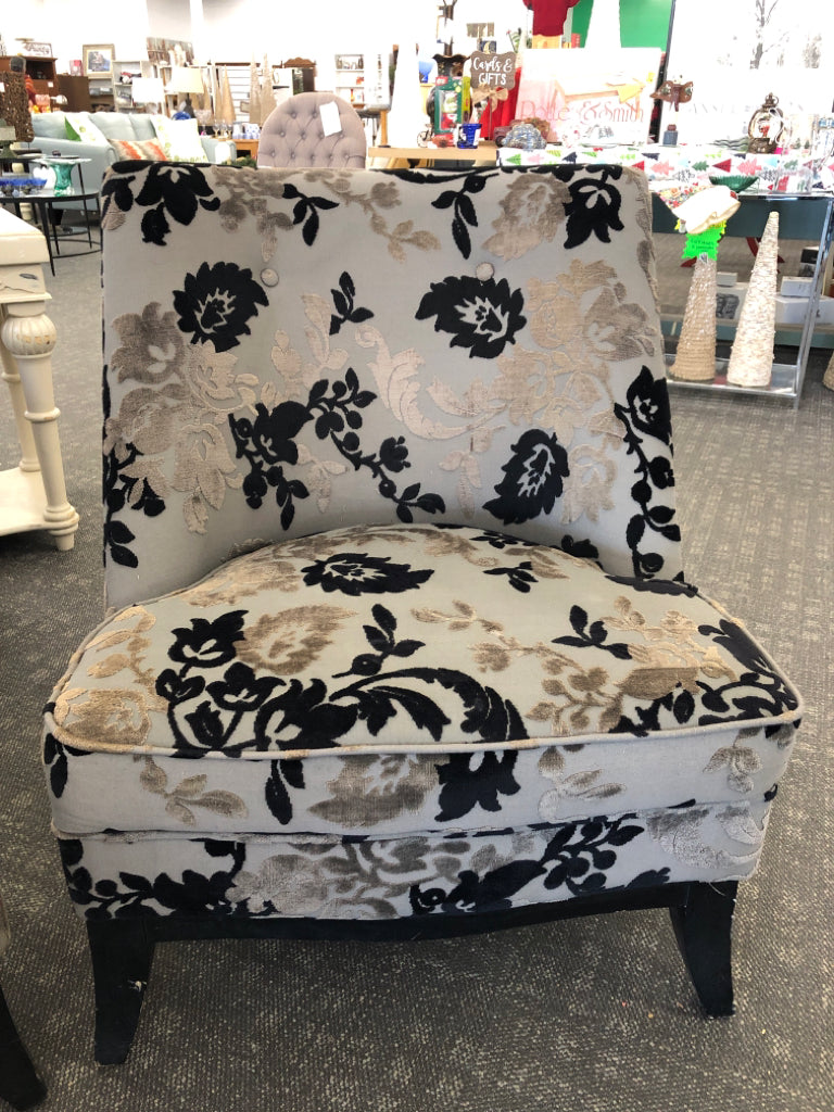 BLACK FLORAL UPHOLSTERED CHAIR W/ WOOD LEGS.