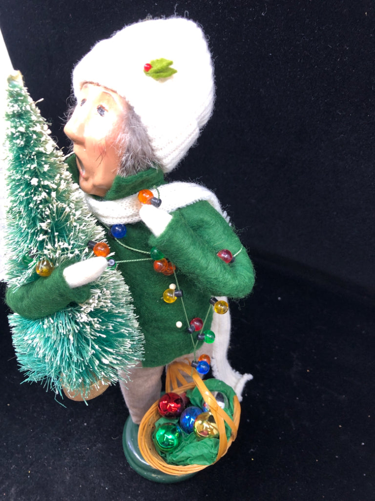 BYERS' CHOICE MAN HOLDING CHRISTMAS TREE- 1996.