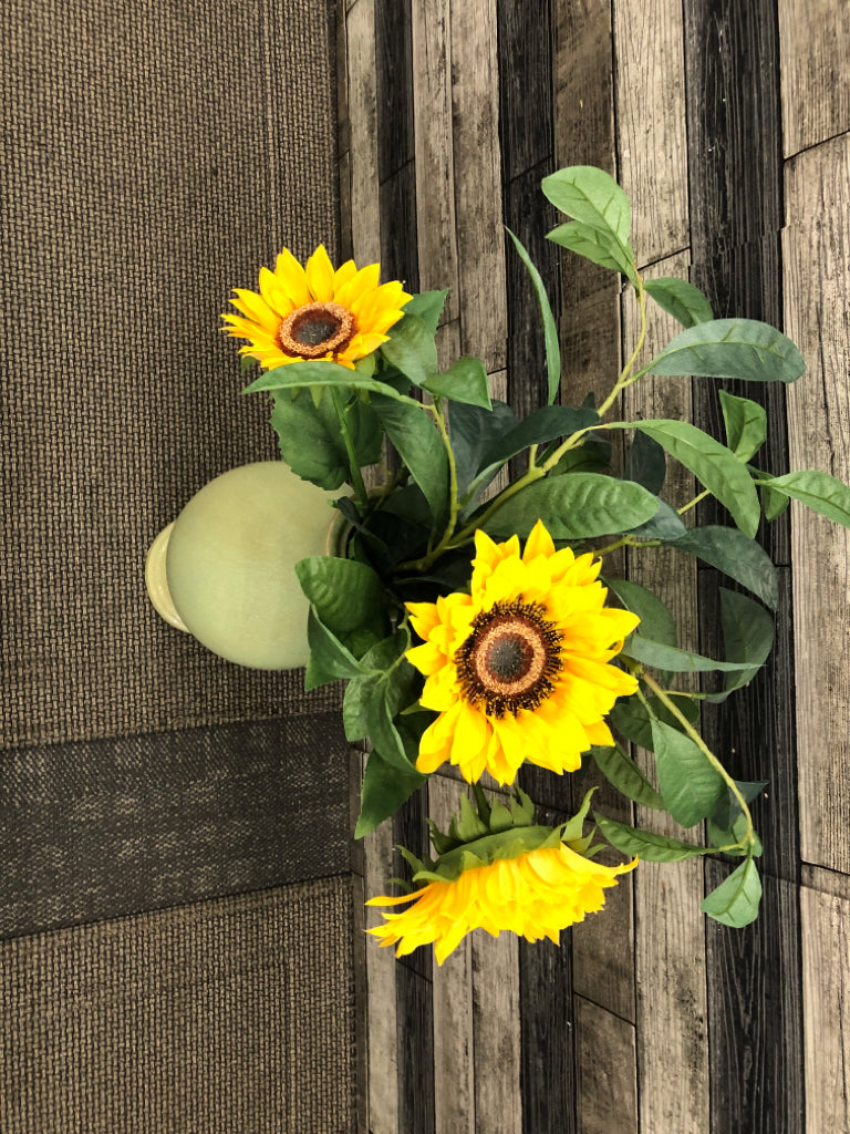 FAUX FLOWERS IN LARGE GREEN VASE.