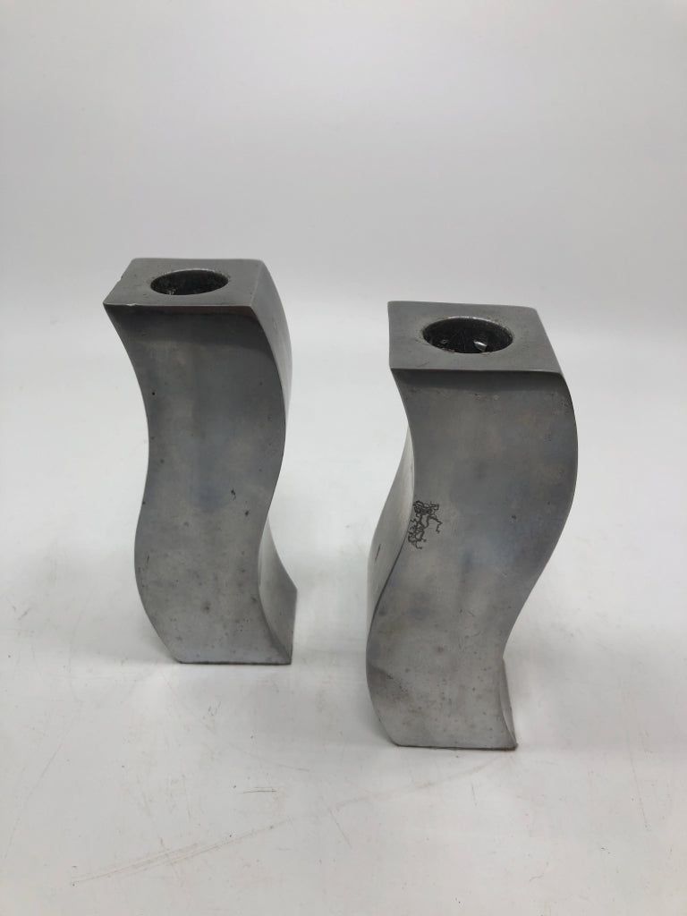 2 CURVY METAL CANDLE STICK HOLDERS.