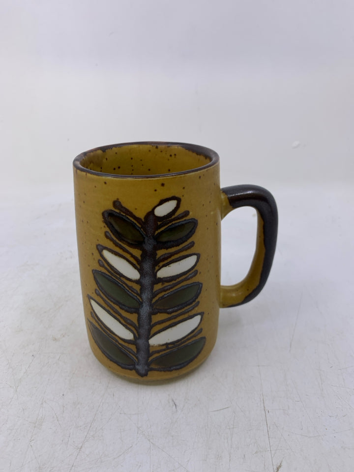 MUSTARD YELLOW POTTERY MUG W/ BROWN FLOWER DESIGN.