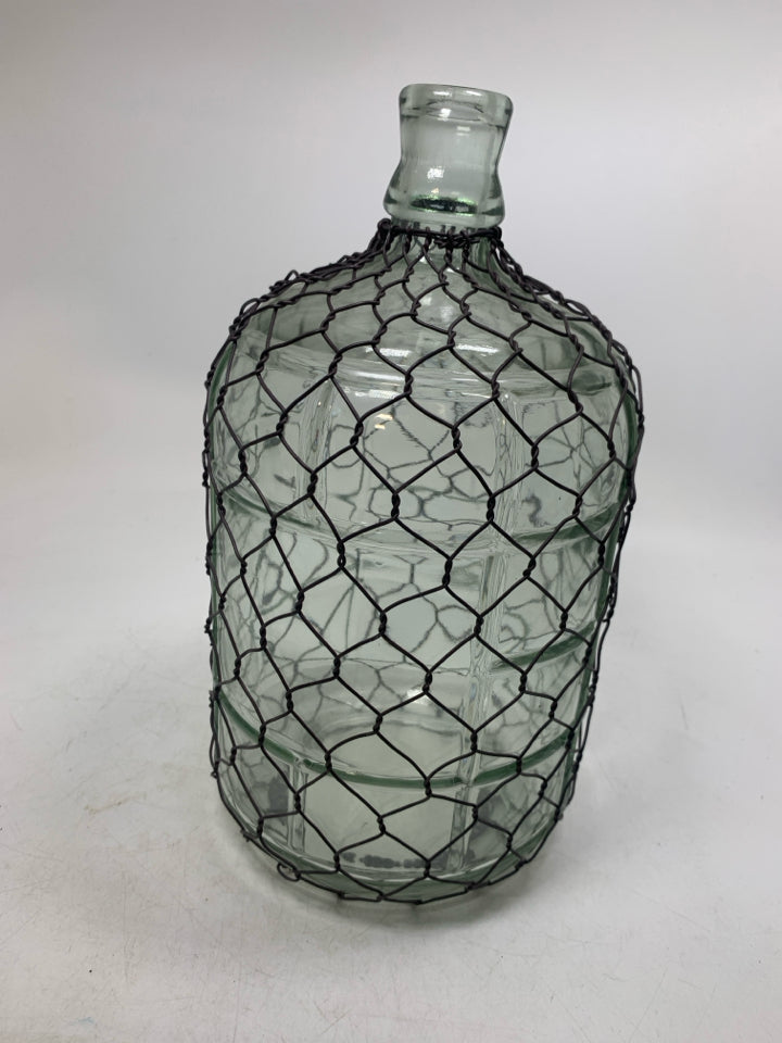 GLASS JUG W/ CHICKEN WIRE COVERING.