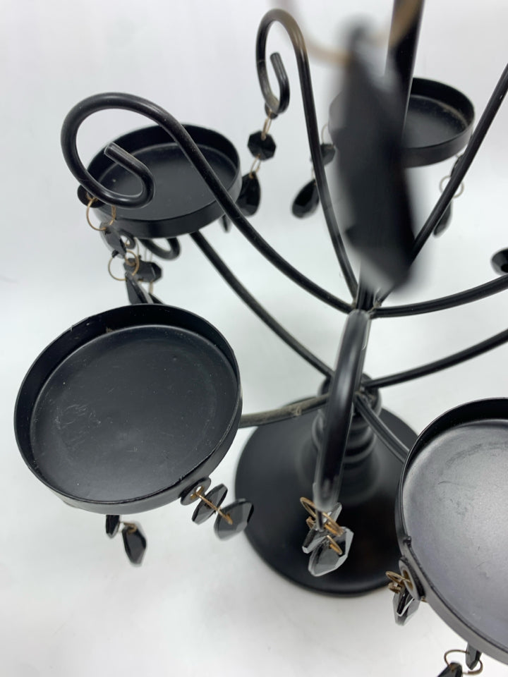 BLACK CANDLE HOLDER W/DANGLING GEMS.