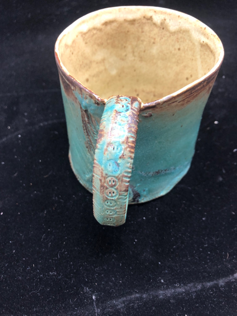 BLUE POTTERY MUG W/EMBOSSED HANDLE.