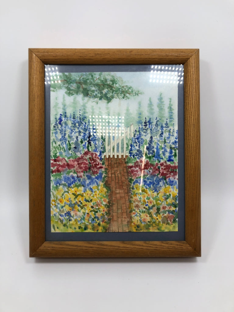 PAINTED GARDEN W/FENCE PRINT IN TAN FRAME.