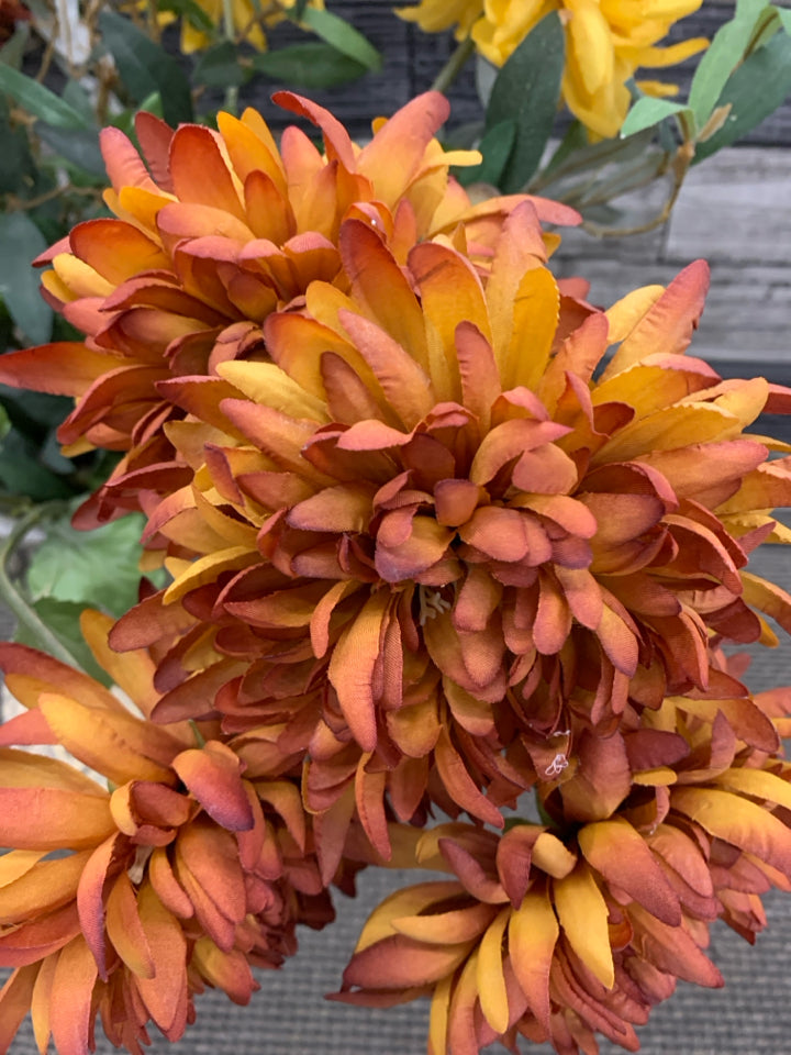 ORANGE AND YELLOW FLORAL IN CARVED POTTERY VASE.