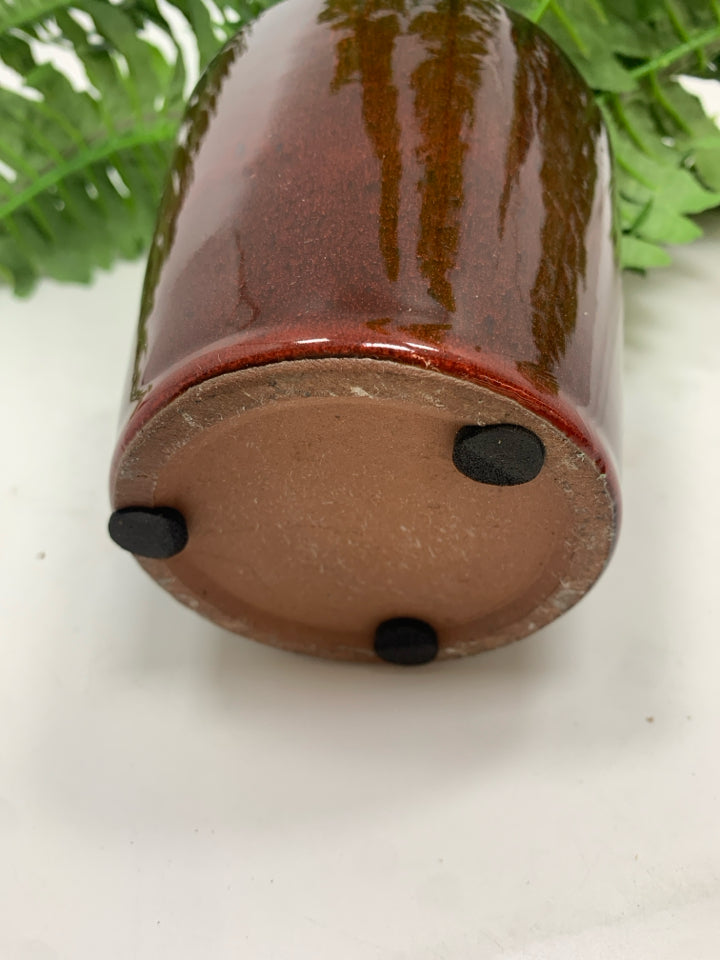 FAUX FERN IN BROWN CERAMIC POT.