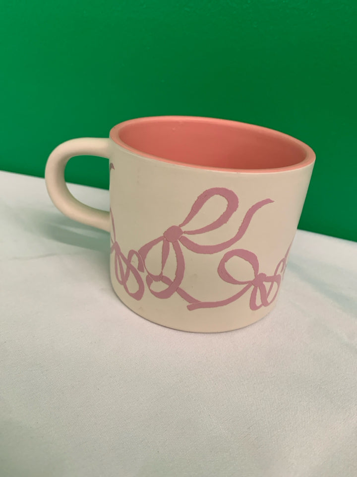 WHITE MATTE MUG W PINK BOWS AND WHITE CAT INSIDE.