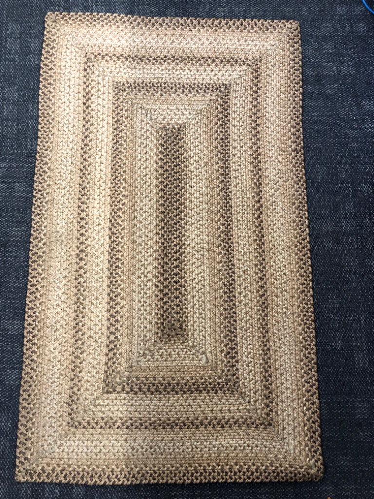 BROWN BRAIDED RECTANGLE AREA RUG.