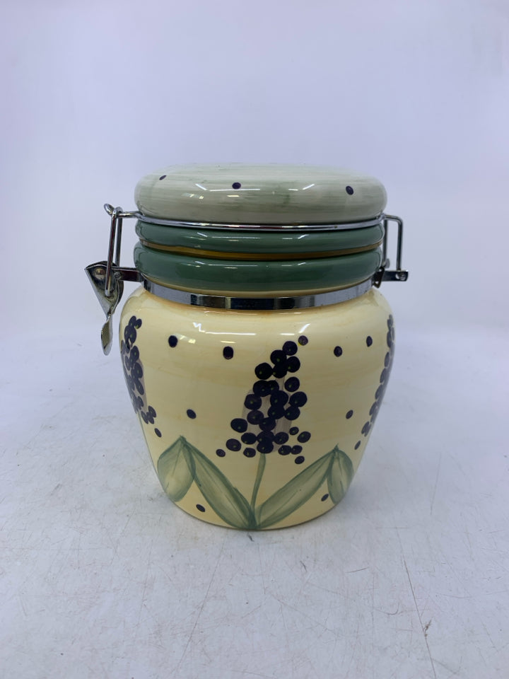 CERAMIC CANISTER W/ PURPLE FLOWERS GREEN POLKA DOT LID.